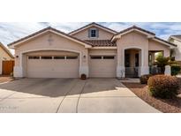 Charming single-story home featuring a two-car garage and well-maintained front yard landscaping at 1493 E Robinson Way, Chandler, AZ 85225