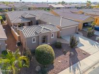 Single-story home with desert landscaping, two-car garage, and a courtyard entry at 42413 W Abbey Rd, Maricopa, AZ 85138