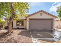 House exterior featuring a two-car garage and well-maintained landscaping at 485 W Fabens Ln, Gilbert, AZ 85233