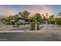 Beautiful mid-century modern home with landscaped front yard and long driveway at 5301 E Mitchell Dr, Phoenix, AZ 85018