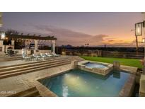Backyard pool and spa featuring outdoor dining area with a built in grill and views of the city at 5427 E Wonderview Rd, Phoenix, AZ 85018