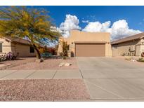 Desert landscape home with driveway and two-car garage at 10454 E Peralta Canyon Dr, Gold Canyon, AZ 85118