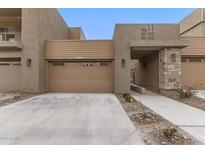 Modern building exterior with attached garage and desert landscaping at 11673 N 136Th St # 1021, Scottsdale, AZ 85259