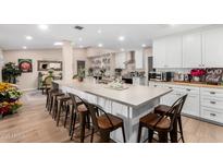 Spacious kitchen with island, stainless steel appliances, and white cabinetry at 12406 W Allegro Dr, Sun City West, AZ 85375