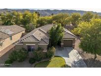 Single-story home with tile roof, two-car garage, and landscaped yard at 1523 E Constance Way, Phoenix, AZ 85042