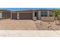 Charming single-story home with a three-car garage and brick paved driveway at 18225 W Hess St, Goodyear, AZ 85338