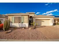 House exterior featuring desert landscaping and a two-car garage at 18258 W Spencer Dr, Surprise, AZ 85374