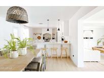 Bright white kitchen with island, stainless steel appliances, and stylish backsplash at 2816 E Cholla St, Phoenix, AZ 85028