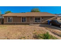 Ranch-style home with a spacious yard and driveway at 2817 W Marshall Ave, Phoenix, AZ 85017