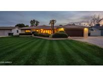 Beautiful single-story home with a well-manicured lawn and a large driveway at 331 E Tuckey Ln, Phoenix, AZ 85012