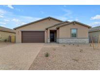 Single-story house with brown garage door and stone accents at 5030 W Hunter Trl, San Tan Valley, AZ 85144