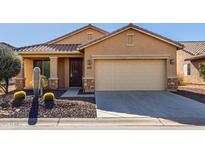 Single-story house with desert landscaping and a two-car garage at 5219 W Buckskin Dr, Eloy, AZ 85131