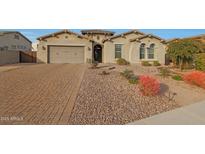 Single-story home with a two-car garage and well-manicured landscaping at 9184 W Donald Dr, Peoria, AZ 85383