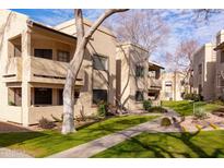 Two-story building with a walkway, landscaping, and parking at 145 N 74Th St # 207, Mesa, AZ 85207