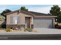 One-story home with gray garage doors and stone accents at 15991 W Cottontail Ln, Surprise, AZ 85387