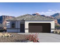 Single-story home with a two-car garage and desert landscaping at 1714 W Spaulding Ave, Apache Junction, AZ 85120