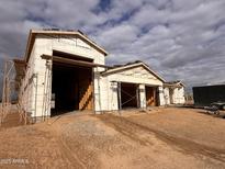 New construction home with two car garage and desert landscaping at 21032 W Skinner Rd, Wittmann, AZ 85361