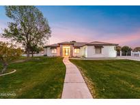 Attractive single-story house with stone accents and landscaped yard at dusk at 21086 E Mewes Rd, Queen Creek, AZ 85142