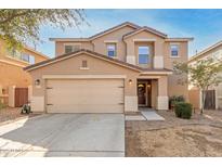 Two-story home featuring a tan exterior, a two-car garage, and manicured landscaping at 2159 S Luther --, Mesa, AZ 85209