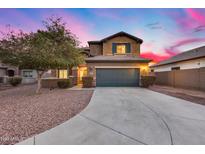 Two-story house with a green garage door and landscaping at 3167 E Battala Ct, Gilbert, AZ 85297