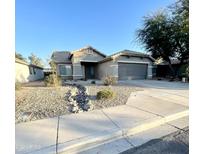 One-story house with a gray garage door and landscaped front yard at 13622 W Peck Ct, Litchfield Park, AZ 85340