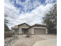 Charming single-story home featuring desert landscaping, neutral paint, and a two-car garage at 13622 W Peck Ct, Litchfield Park, AZ 85340
