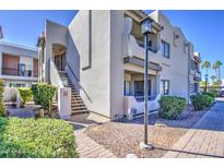 Inviting condo exterior featuring a charming facade, desert landscaping, and stairs leading to upper units at 3640 N 38Th St # 104, Phoenix, AZ 85018