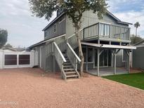 Two-story house with a deck, stairs, and a fenced yard at 4127 E Maldonado Dr, Phoenix, AZ 85042