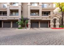 Building exterior featuring multiple units with attached garages and a well-maintained courtyard at 4455 E Paradise Village S Pkwy # 1031, Phoenix, AZ 85032