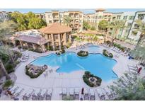 Resort-style pool with surrounding lounge chairs and landscaping at 5450 E Deer Valley Dr # 4015, Phoenix, AZ 85054