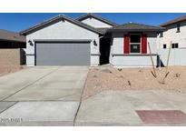 New single-story home with gray two-car garage and red shutters at 7366 E Hackamore Ln, San Tan Valley, AZ 85143