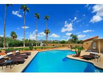 Inviting pool with lounge chairs, offering scenic mountain views at 9748 E Becker Ln, Scottsdale, AZ 85260
