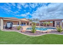 Spacious backyard with a pool, hot tub, and entertainment area at 9911 W Jessie Ln, Peoria, AZ 85383