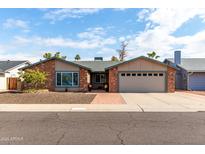 Charming brick and stucco home with a well-manicured front yard and inviting curb appeal at 11427 S Tomah St, Phoenix, AZ 85044