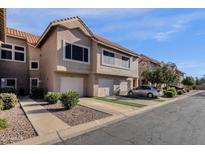 Charming townhome with desert landscaping, attached garage, and private driveway at 1633 E Lakeside Dr # 127, Gilbert, AZ 85234