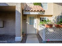 Inviting condo entry with tiled walkway and potted plants at 1633 E Lakeside Dr # 45, Gilbert, AZ 85234