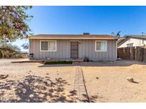 Ranch style home with a gray exterior and a small front yard at 21701 W Griffin Ave, Wittmann, AZ 85361