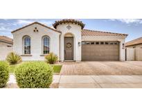 Spanish-style home with a two-car garage and landscaped front yard at 22235 E Cherrywood Dr, Queen Creek, AZ 85142