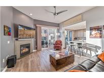 Open living room with fireplace, balcony access, and modern furniture at 2302 N Central Ave # 401, Phoenix, AZ 85004