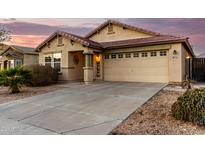 One-story house with attached garage, landscaping, and a paved driveway at 24246 W Tonto St, Buckeye, AZ 85326