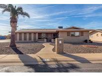 Brick ranch house with a landscaped front yard and walkway at 6457 E Dallas St, Mesa, AZ 85205