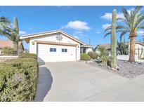 House exterior showcasing a well-maintained front yard, driveway, and garage at 745 Leisure World --, Mesa, AZ 85206