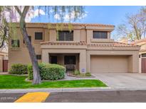 Two-story house with a tan exterior, two-car garage, and landscaped front yard at 9030 S Maple Ave, Tempe, AZ 85284