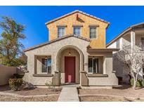 Two-story house with red door and neutral exterior at 106 N 66Th Ave, Phoenix, AZ 85043