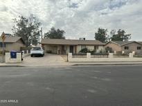 Ranch style home with carport and small front yard at 1321 W Pueblo Ave, Mesa, AZ 85202