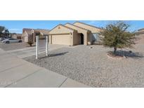 Single-story house with a two-car garage and landscaped front yard at 16060 W Lupine Ave, Goodyear, AZ 85338