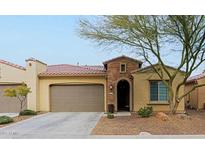 Single-story home with a two-car garage and desert landscaping at 16918 W Palm Ln, Goodyear, AZ 85395