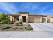Single-story home with three-car garage and desert landscaping at 19684 N 260Th Ave, Buckeye, AZ 85396