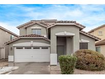 Two-story house with a two-car garage and landscaping at 44230 W Palmen Dr, Maricopa, AZ 85138