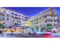 Night view of building exterior, highlighting architectural details and courtyard at 6803 E Main St # 1110, Scottsdale, AZ 85251